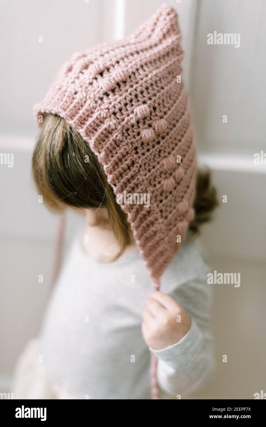 pink crochet wool bonnet hat posing 