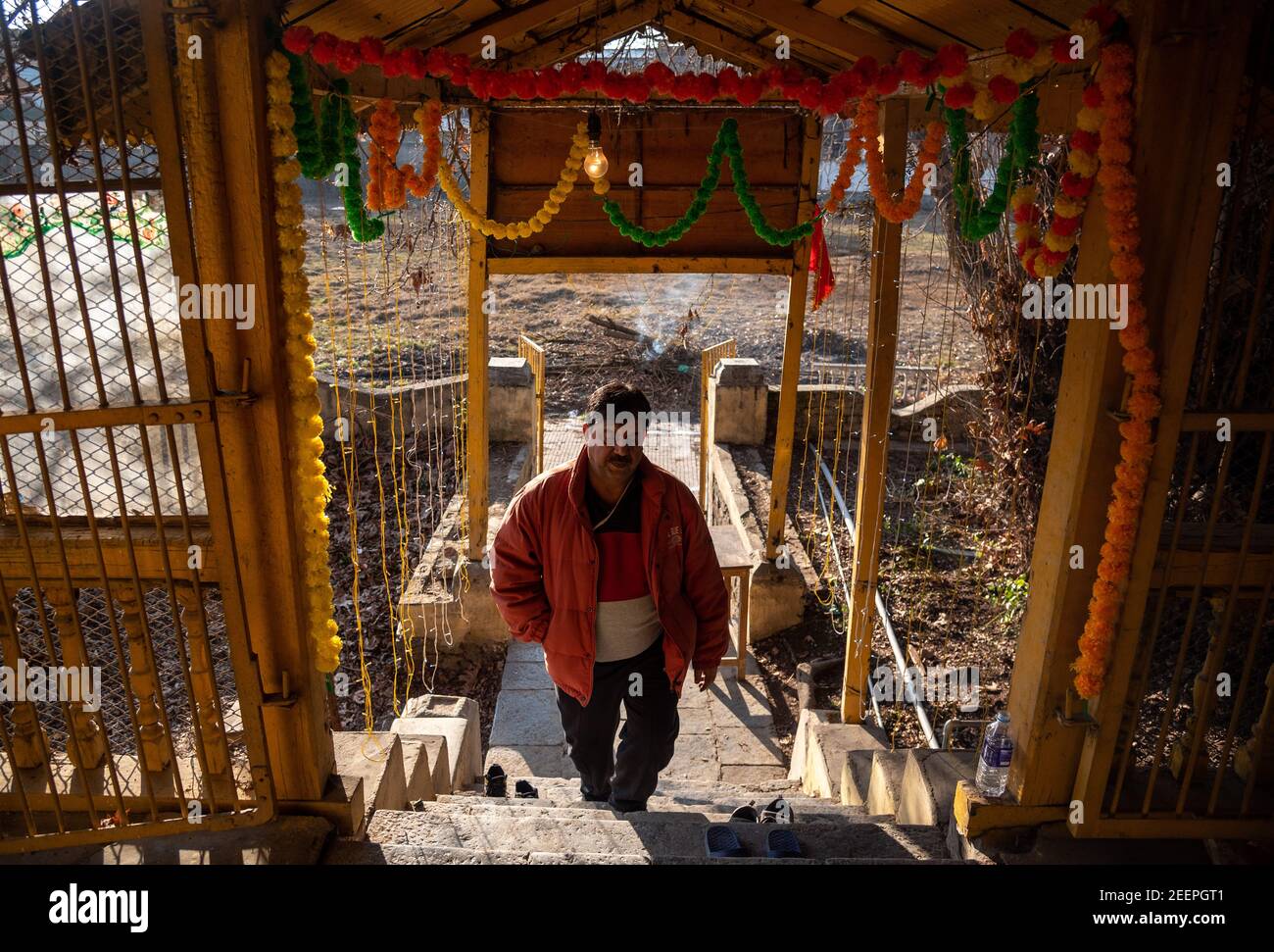 A Kashmiri pandit devotee entering the Shital Nath Temple which was reopened after 31 years.The temple was closed in the early 90s following the migration of Pandits from the valley in the wake of militancy. Stock Photo