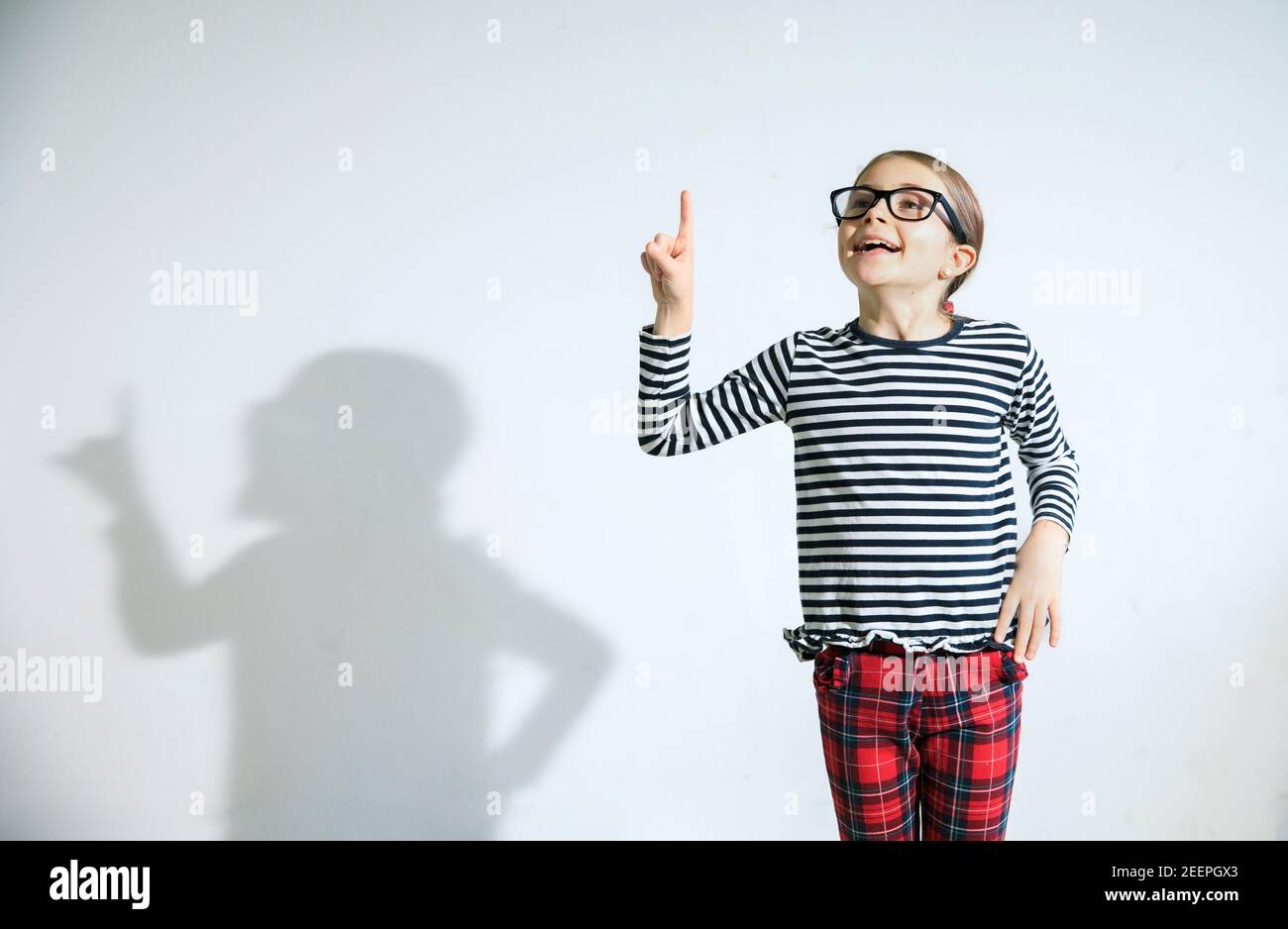 Quirky Kid Wearing Black Glasses Eager With An Idea To Share Stock Photo