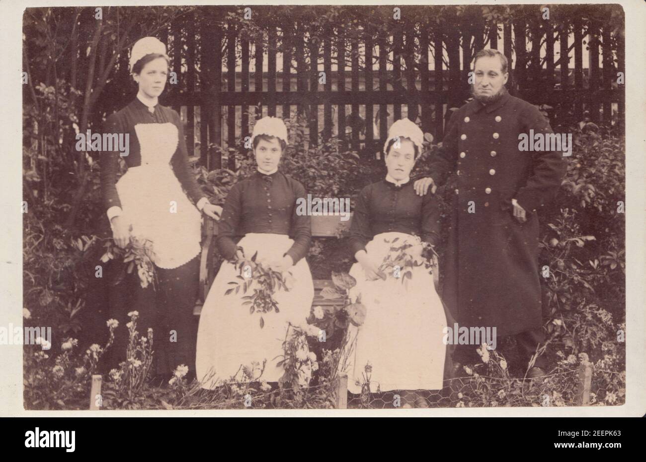 Victorian Bootle Cabinet Card Showing Three Female and One Male Domestic Servant in a Garden. Stock Photo