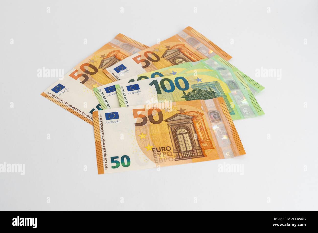 Banknotes on white background. Fifty and one hundred Euro notes in orange and green color. Currency of Europe. Stock Photo