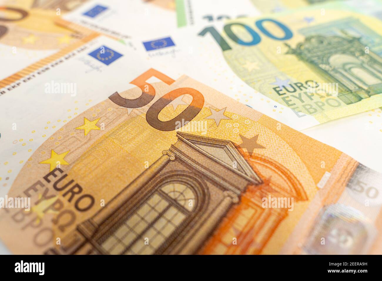 Banknotes background. Fifty and one hundred Euro notes in orange and green color covering the floor. Currency of Europe. Stock Photo