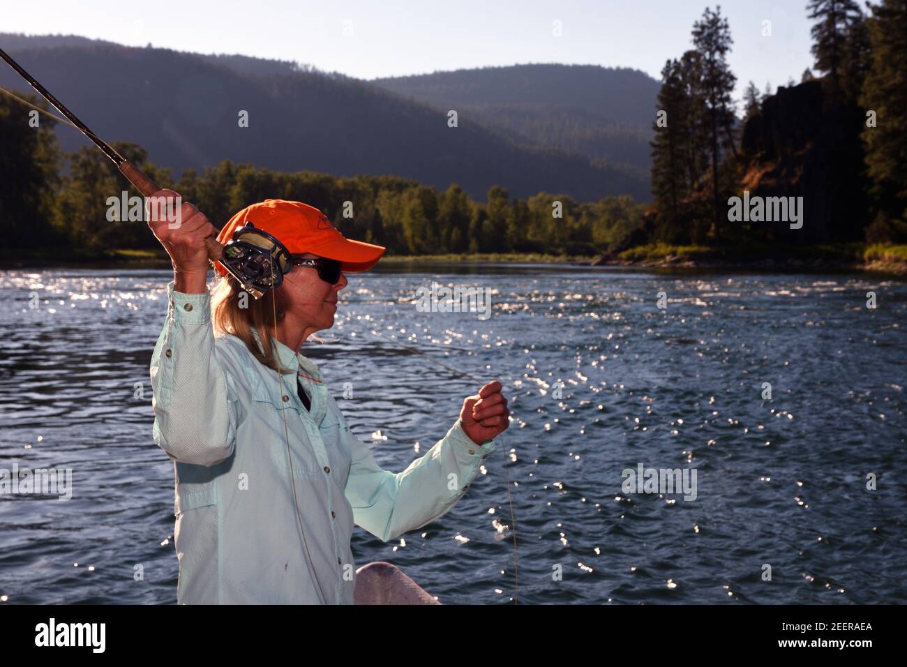 Joanne Linehan fly fishing the Kootenai River in summer. Lincoln County, Montana. (Photo by