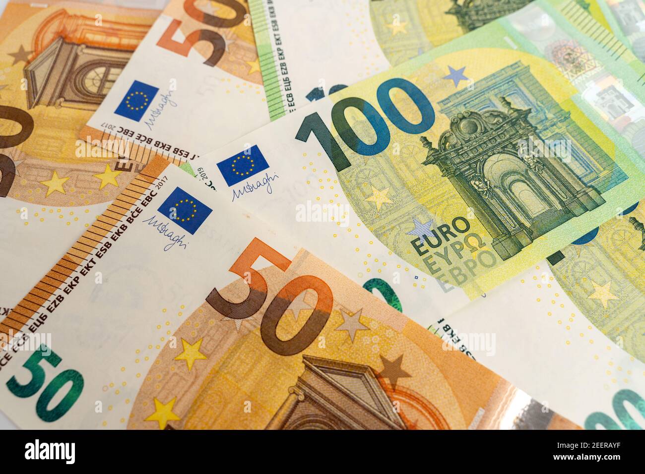 Banknotes background. Fifty and one hundred Euro notes in orange and green color covering the floor. Currency of Europe. Stock Photo