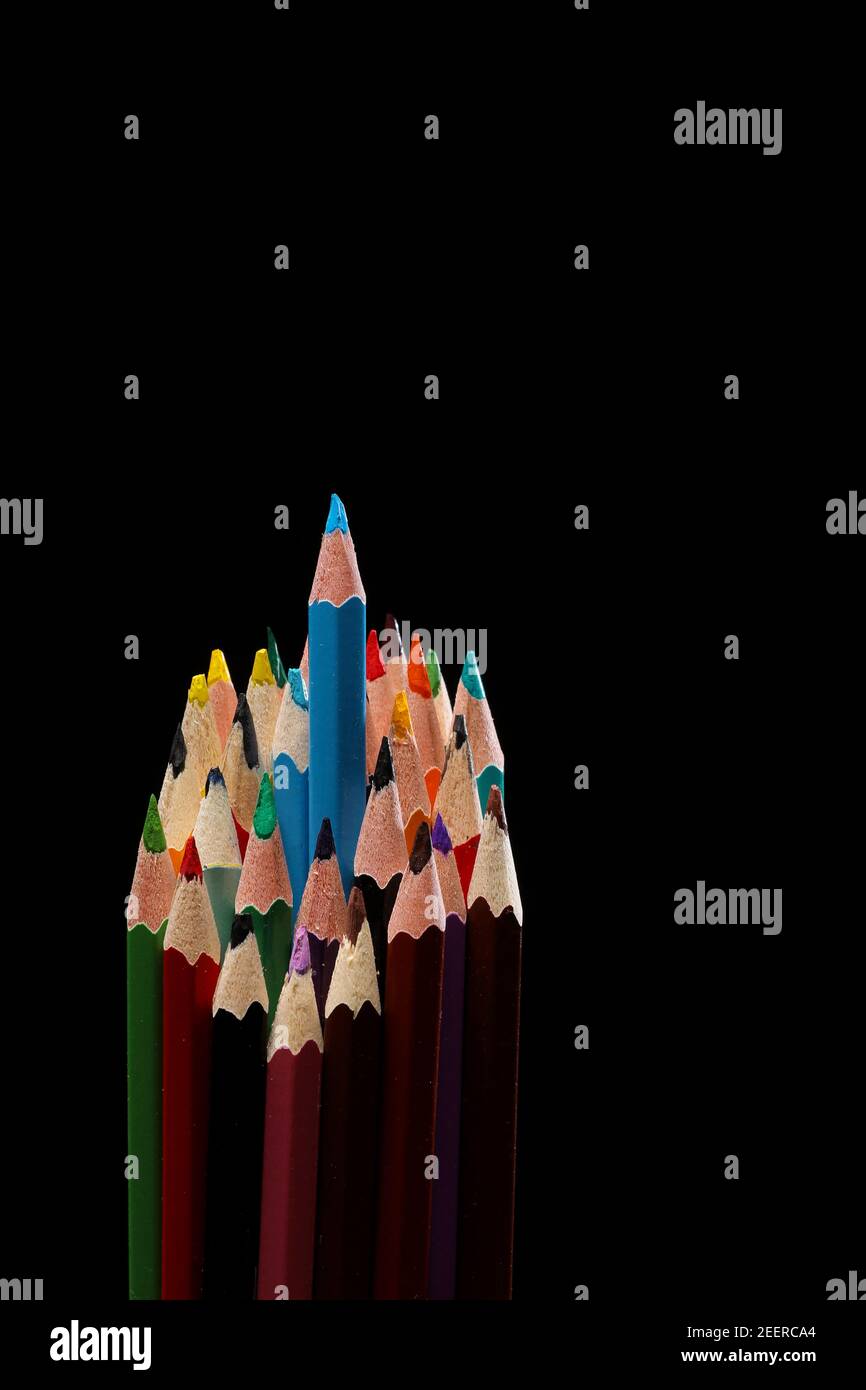 blue color pencil stands out among many color pencils on black