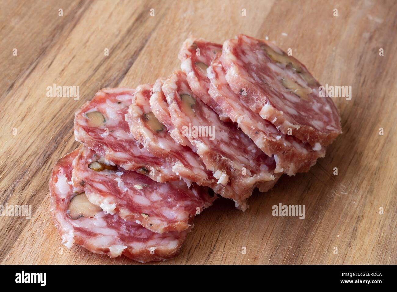 Sliced Airdried salami wood background Stock Photo Alamy
