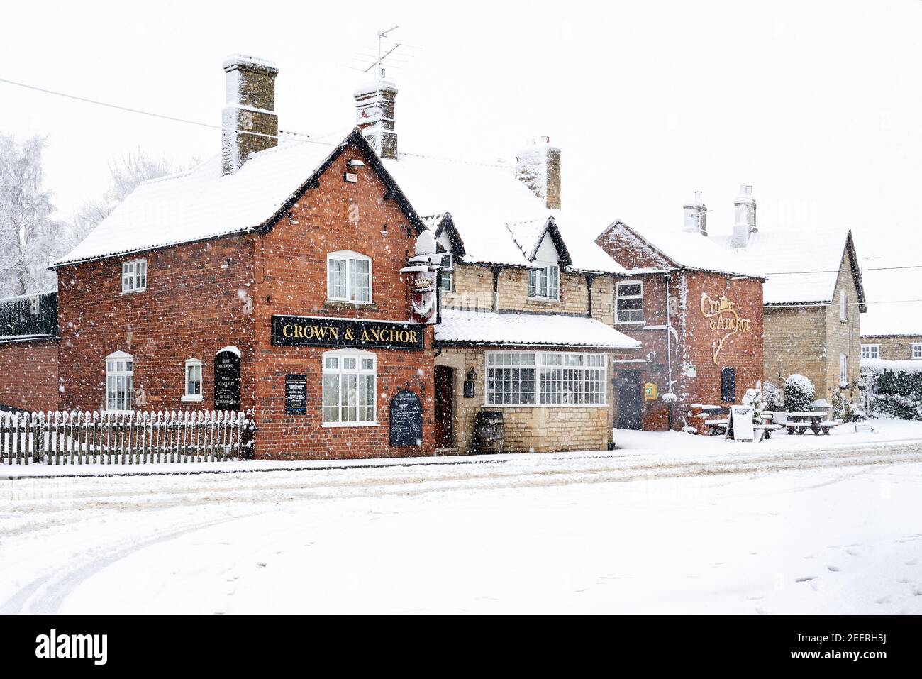 The Crown and Actor Pub in Welby, Lincolnshire white over with snow during a winter storm December 2020 Stock Photo