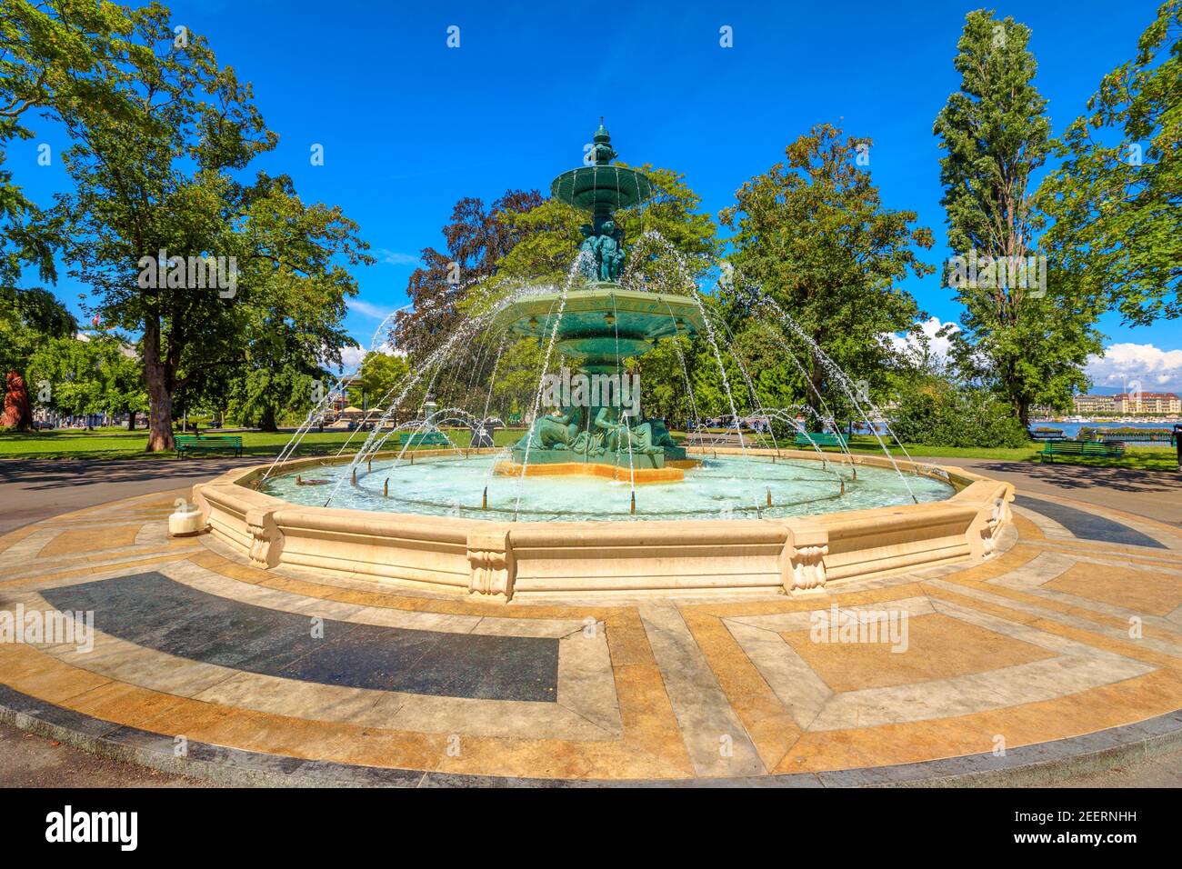 Fountain of Four Seasons in center of Jardin Anglais and promenade du Lac in Geneva, Switzerland. Geneva Lake, waterfront and bay on background. Stock Photo