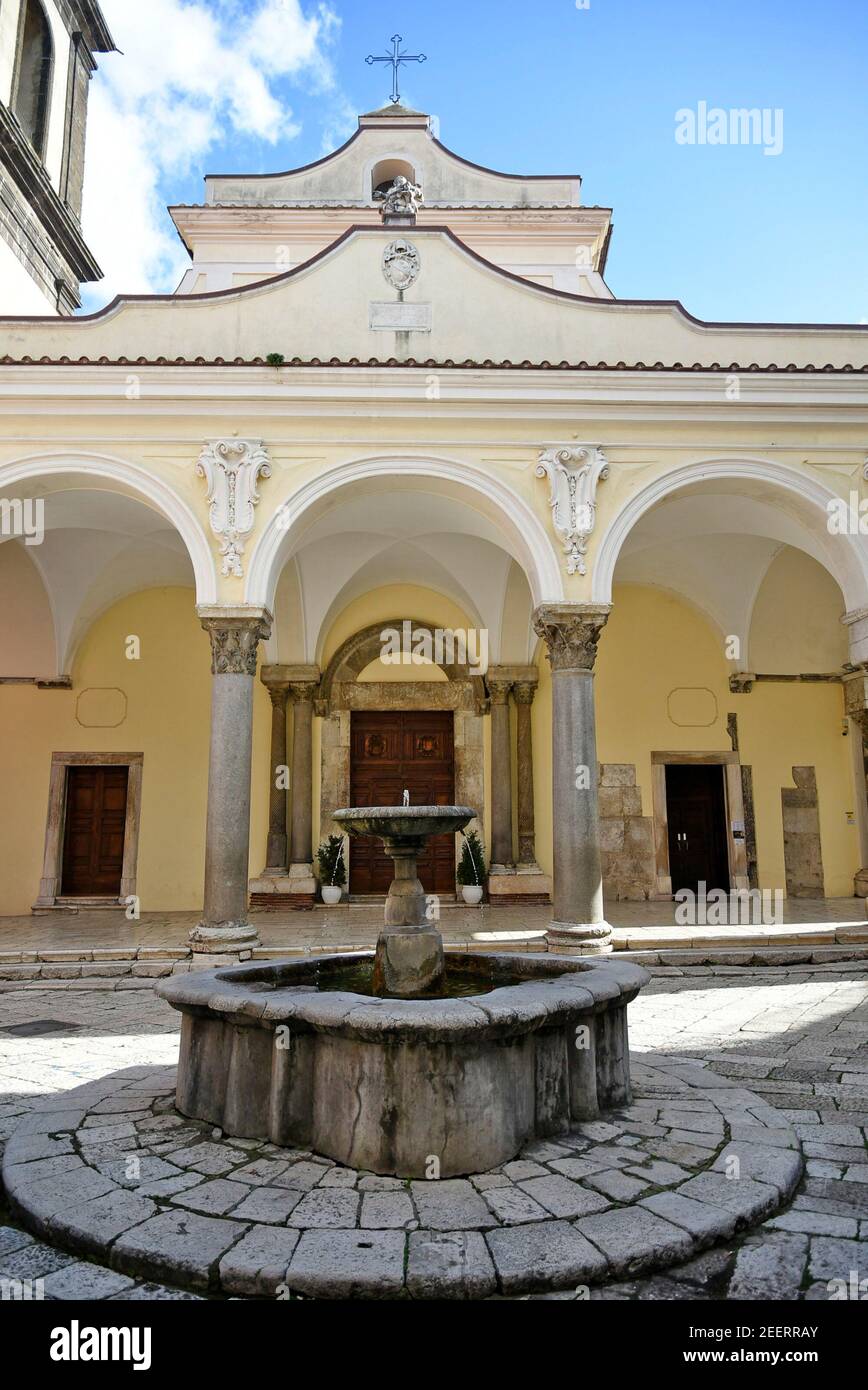 A well in front of the church in the square of an old town in the province of Benevento. Stock Photo