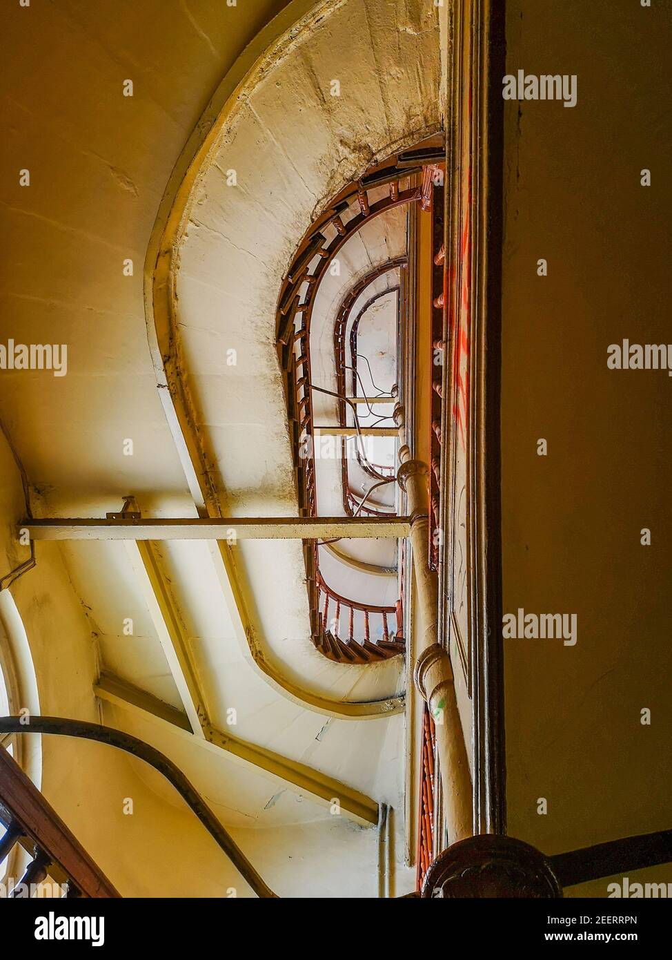 Lookup to spiral staircase in old tenement house Stock Photo