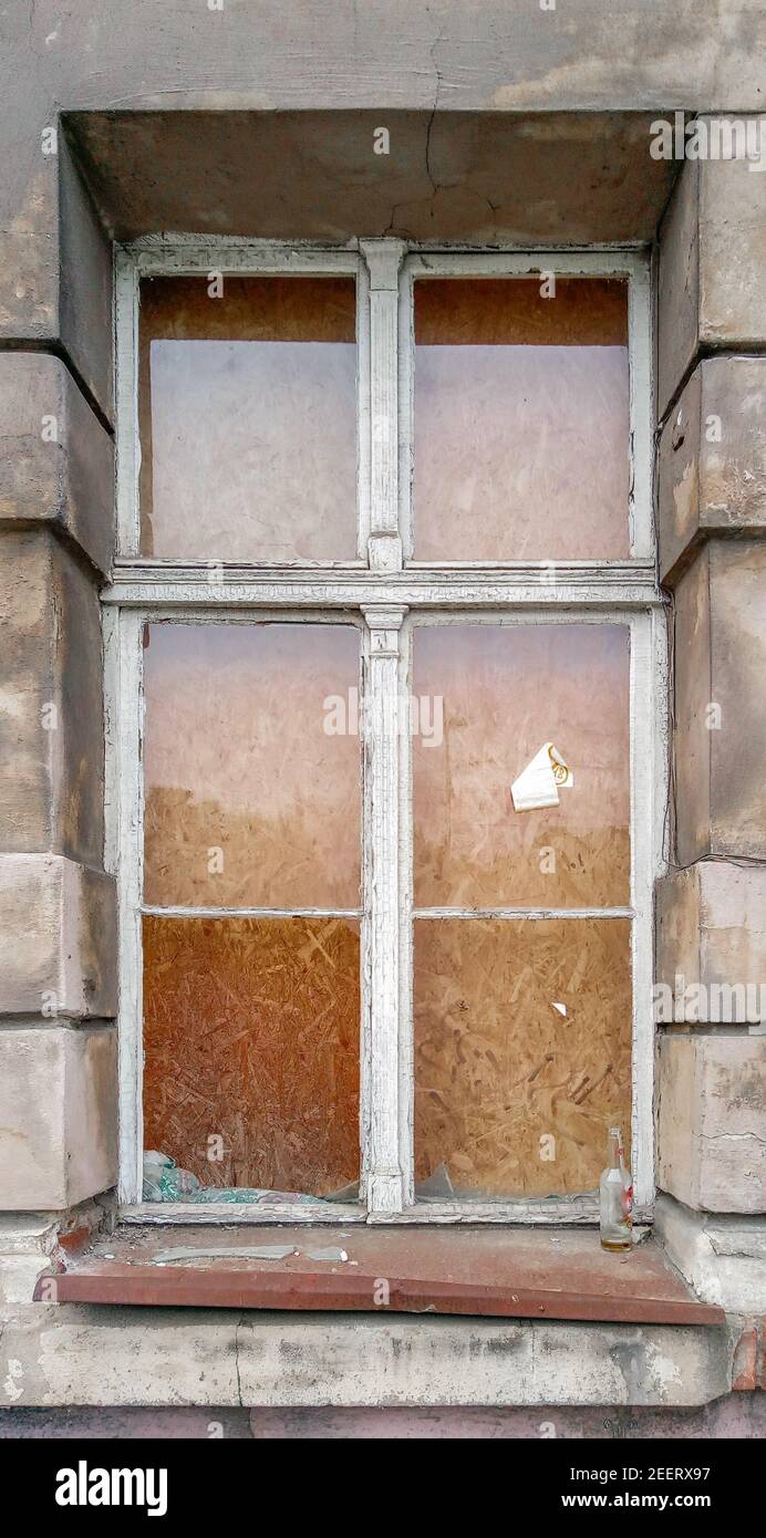 Broken glass in old wooden window of old tenement house in Wroclaw city Stock Photo