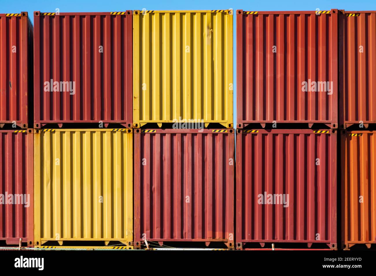 Piled red and yellow containers for merchandise transport, without ...