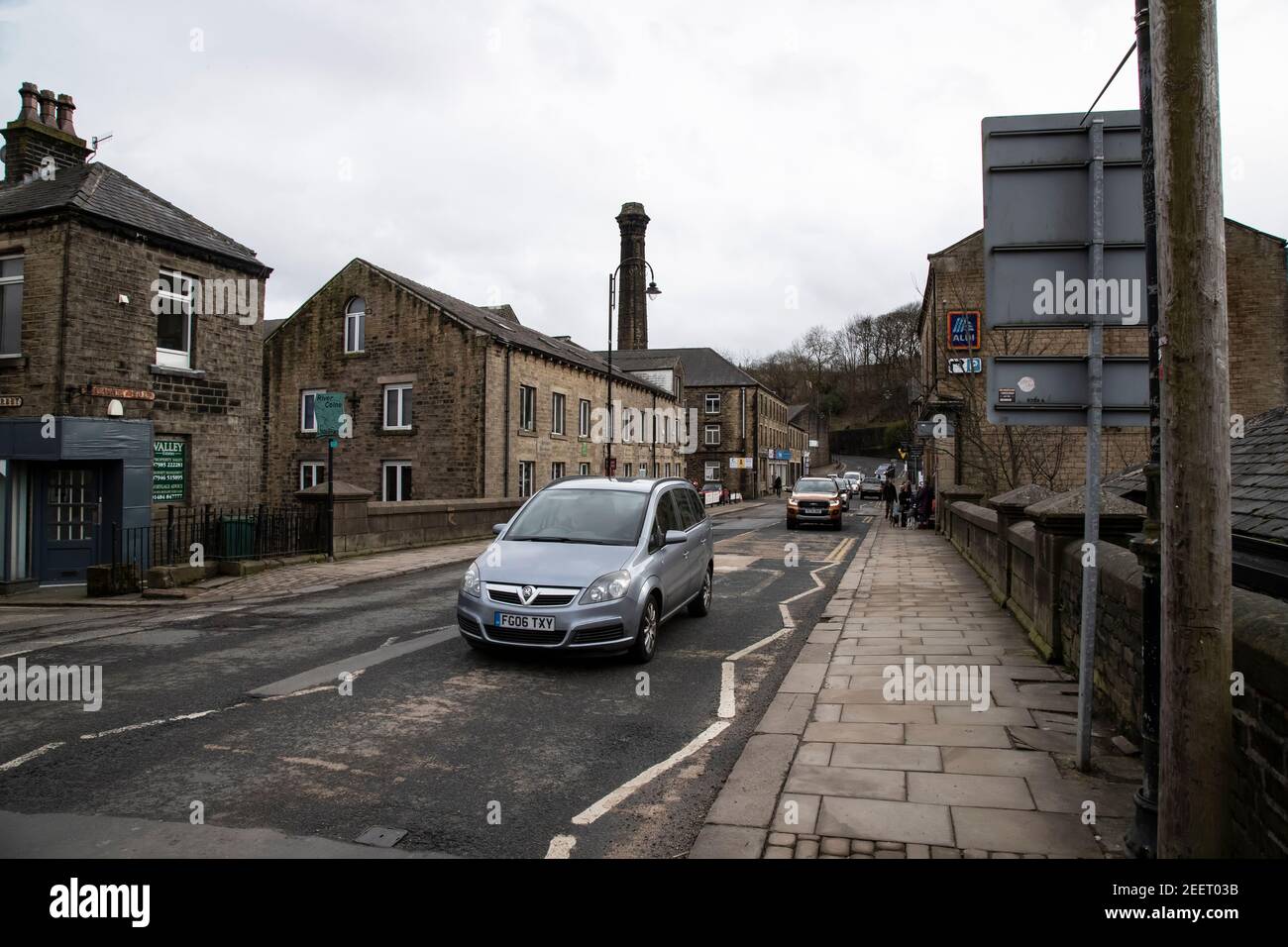 Light traffic moves steadily along Britannia Road in Slaithwaite village a typical North England town South West of Huddersfield in West Yorkshire, UK Stock Photo