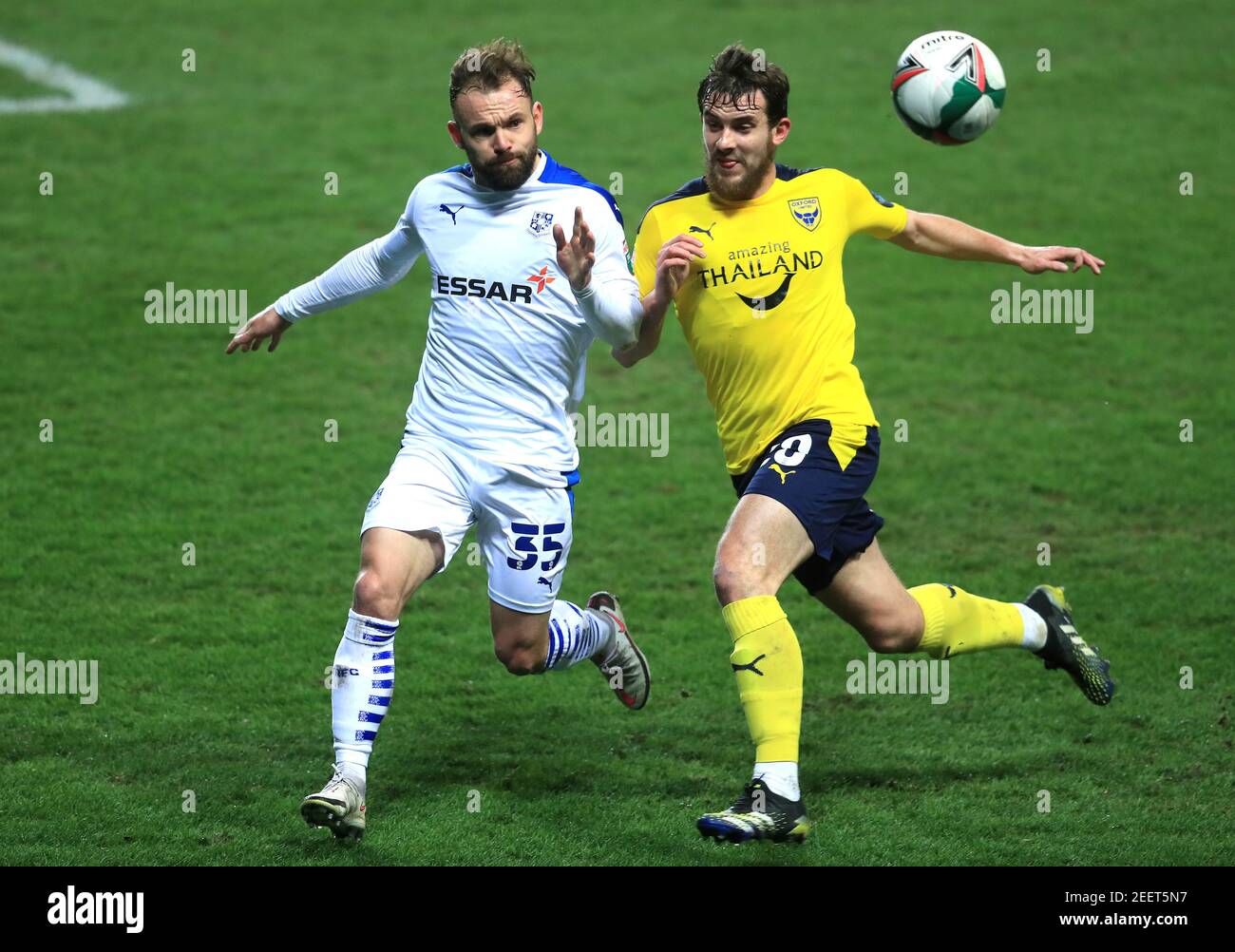 Tranmere Rovers' Danny Lloyd (left) and Oxford United's Jamie Hanson battle for the ball during the Papa John's Trophy semi final match at the Kassam Stadium, Oxford. Picture date: Tuesday February 16, 2021. Stock Photo