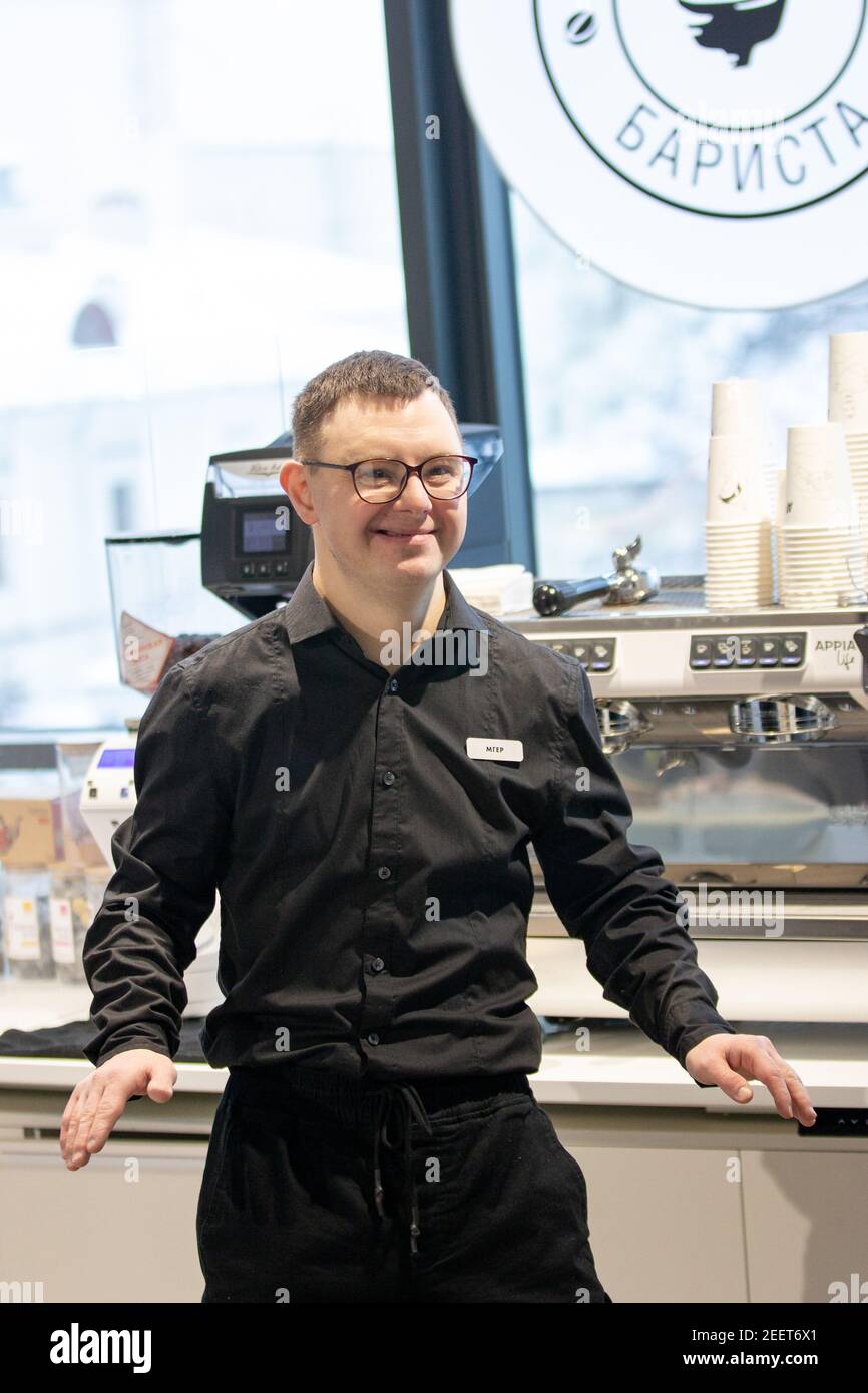 MINSK, BELARUS - January 2021: Disability Inclusion Team at an inclusive cafe. A unique project, an inclusive coffee shop. A place where all employees are disabled. Managed by a person with Down syndrome. All baristas are disabled. This is Mher Minosyan. He is 29 years old. Down syndrome. Works as a barista in an inclusive coffee shop. Leads a healthy lifestyle and enjoys sports. Stock Photo