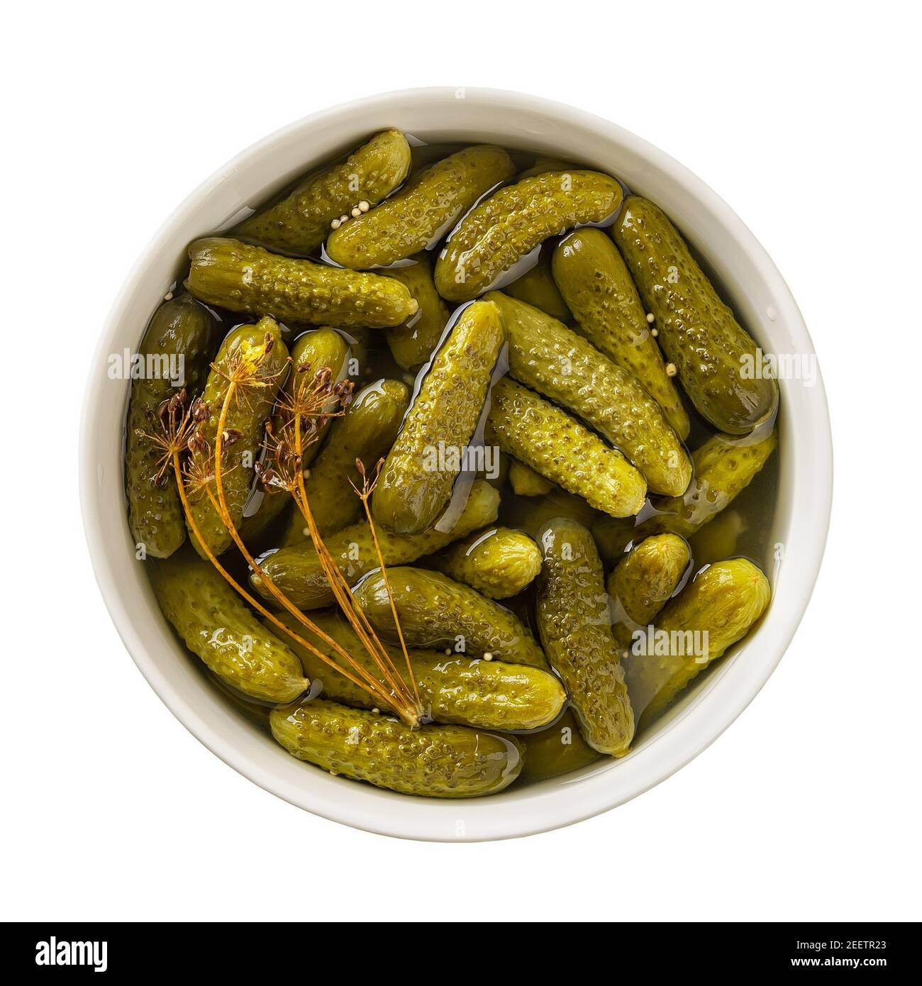 Delicious pickled cornichons in a ceramic bowl isolated on white background. Whole green