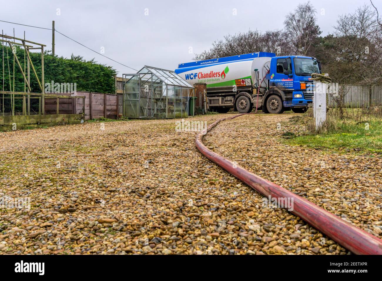 A W C F Chandlers tanker delivering domestic heating oil to a house in the country. Stock Photo