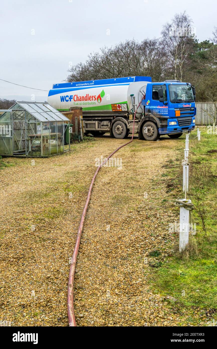 A W C F Chandlers tanker delivering domestic heating oil to a house in the country. Stock Photo