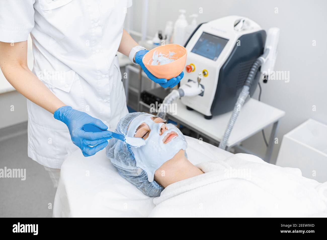 Rejuvenation and moisturizing of facial skin with an alginate mask in a modern cosmetology clinic. Stock Photo