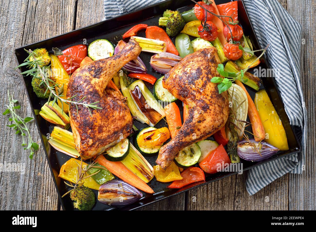 Two crispy oven roasted chicken legs on colorful mediterranean