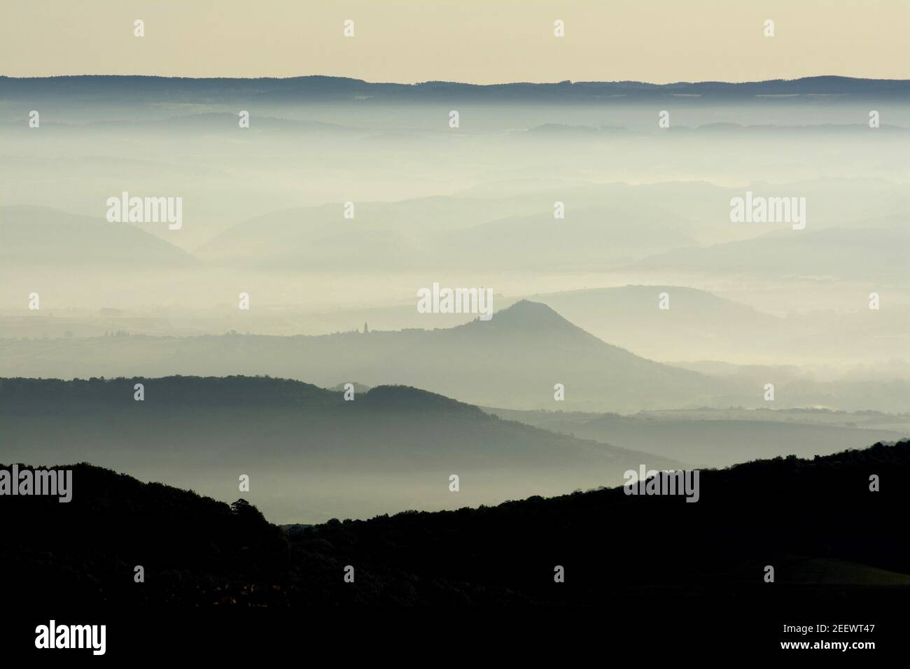 Aerial shot of mountains in layers under a foggy sky Stock Photo - Alamy