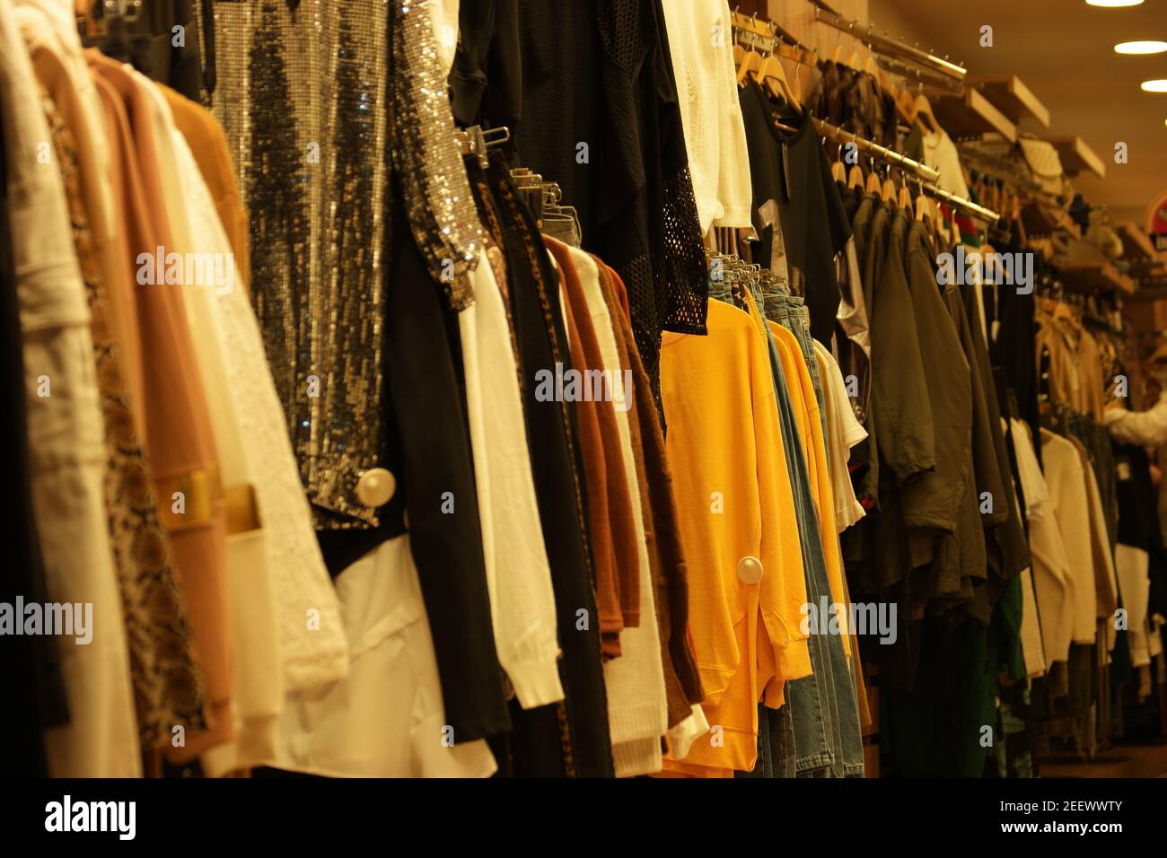 Clothes hanging on rack close up. Stock Photo