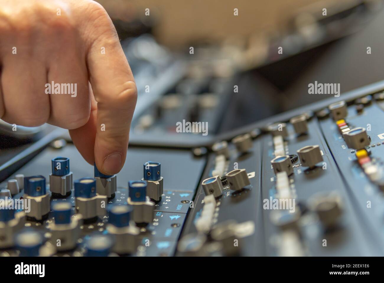 Closeup of a finger using a profesional soundboard in a music studio
