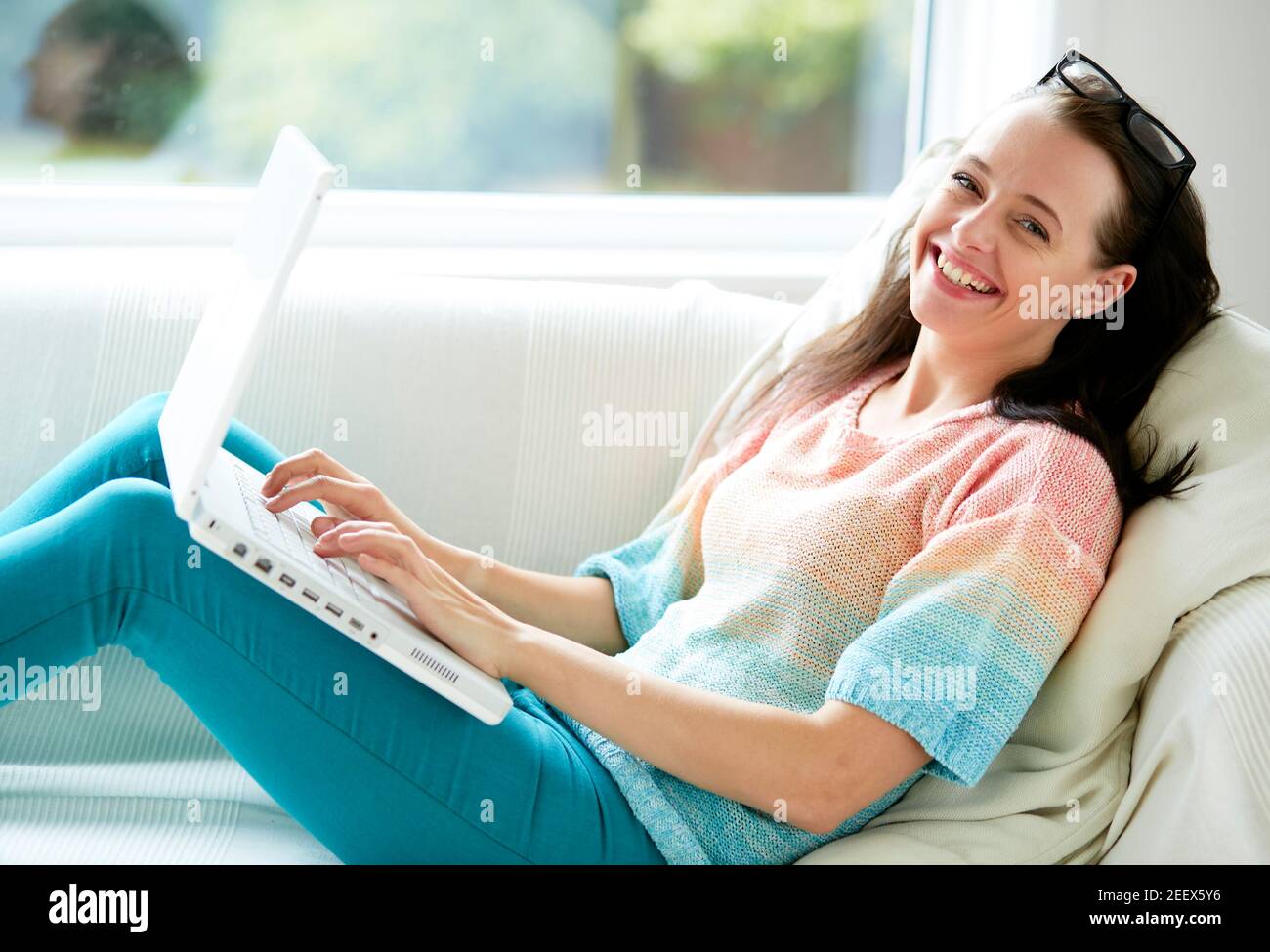 Woman smiling using laptop Stock Photo