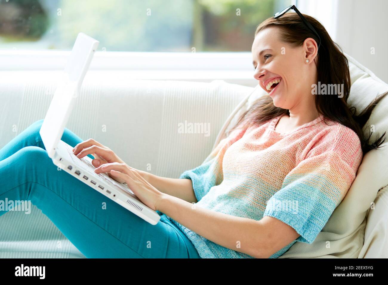 Woman smiling using laptop Stock Photo