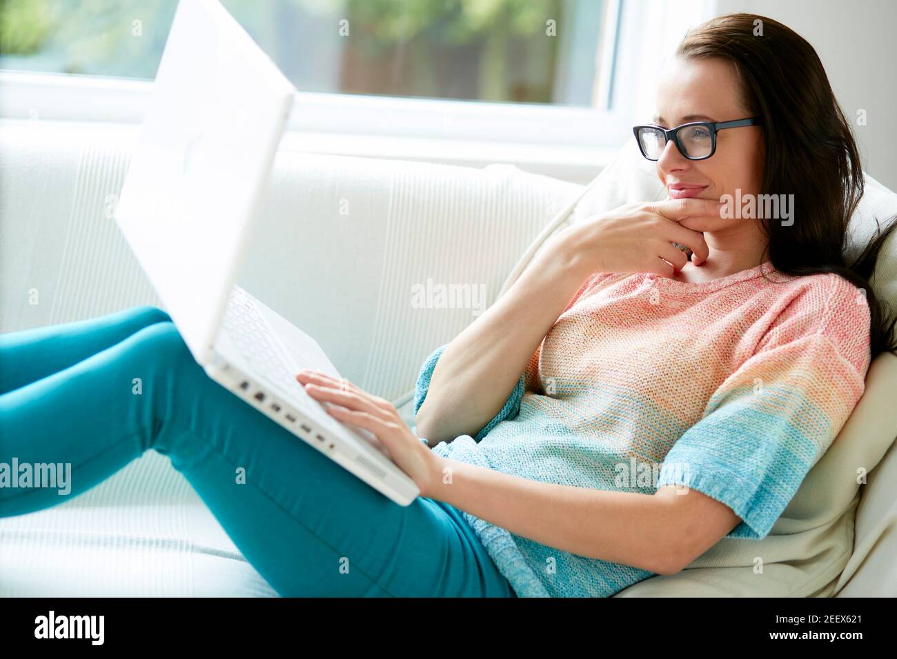 Woman smiling using laptop Stock Photo