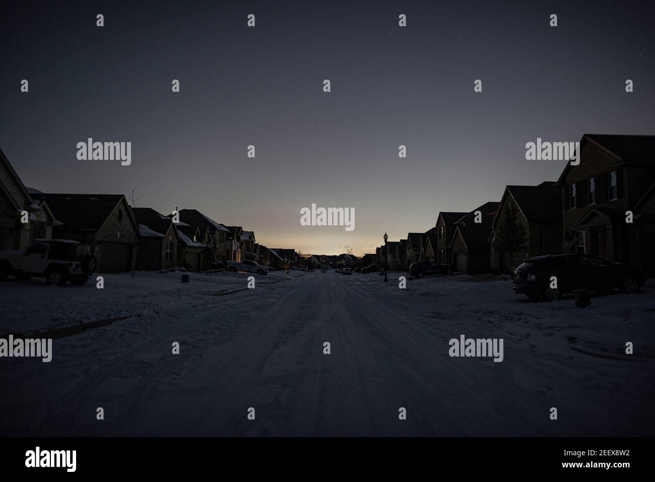 Argyle, Texas, USA. 15th Feb, 2021. After a snowstorm hits the state of Texas, many Texans are left without power. The state of Texas has chosen to use the rolling blackout to save energy in the state. 2/15/21, Argyle, Texas. In Argyle, Texas, families use canal light at night and try their best to cope with the situation. The Olson family, who has tested positive for COVID-19 seven days ago, has been experiencing blackouts the whole day. I the morning, this family and their neighbors have lost water pressure due to a tripped pump in the city. (Credit Image: © Chris Rusanowsky/ZUM Stock Photo