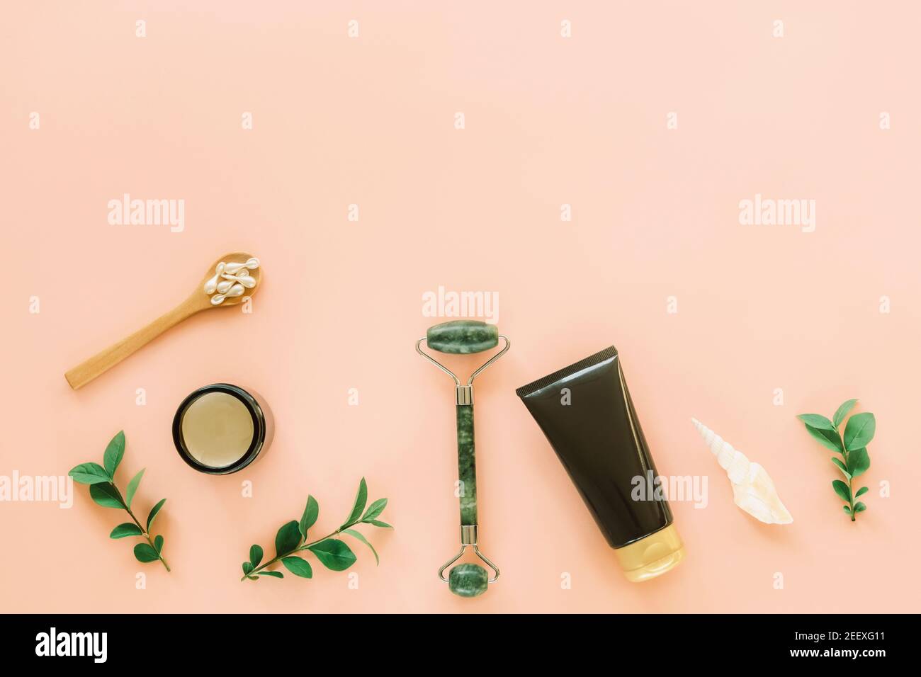 Natural cosmetics and face roller on coral colored background. Eco friendly and zero waste concept. Top view, flat lay, copy space. Stock Photo