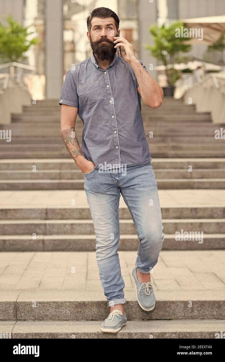 Casual conversation. Hipster in casual style urban outdoor. Bearded man  talk on mobile phone. Casual fashion trends. Fashion and style. Everyday  wear. Casual menswear store. Modern life Stock Photo - Alamy