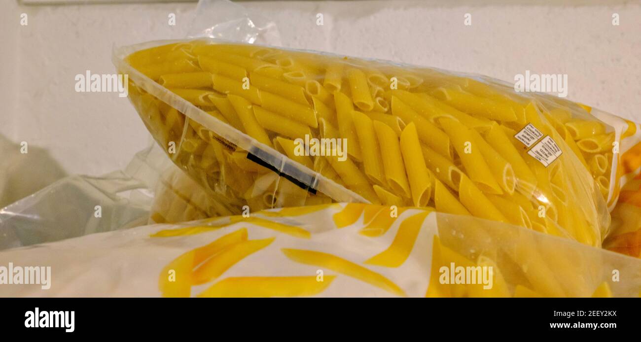 Packets of pasta in a crate of dry packet food donations in a Trussell