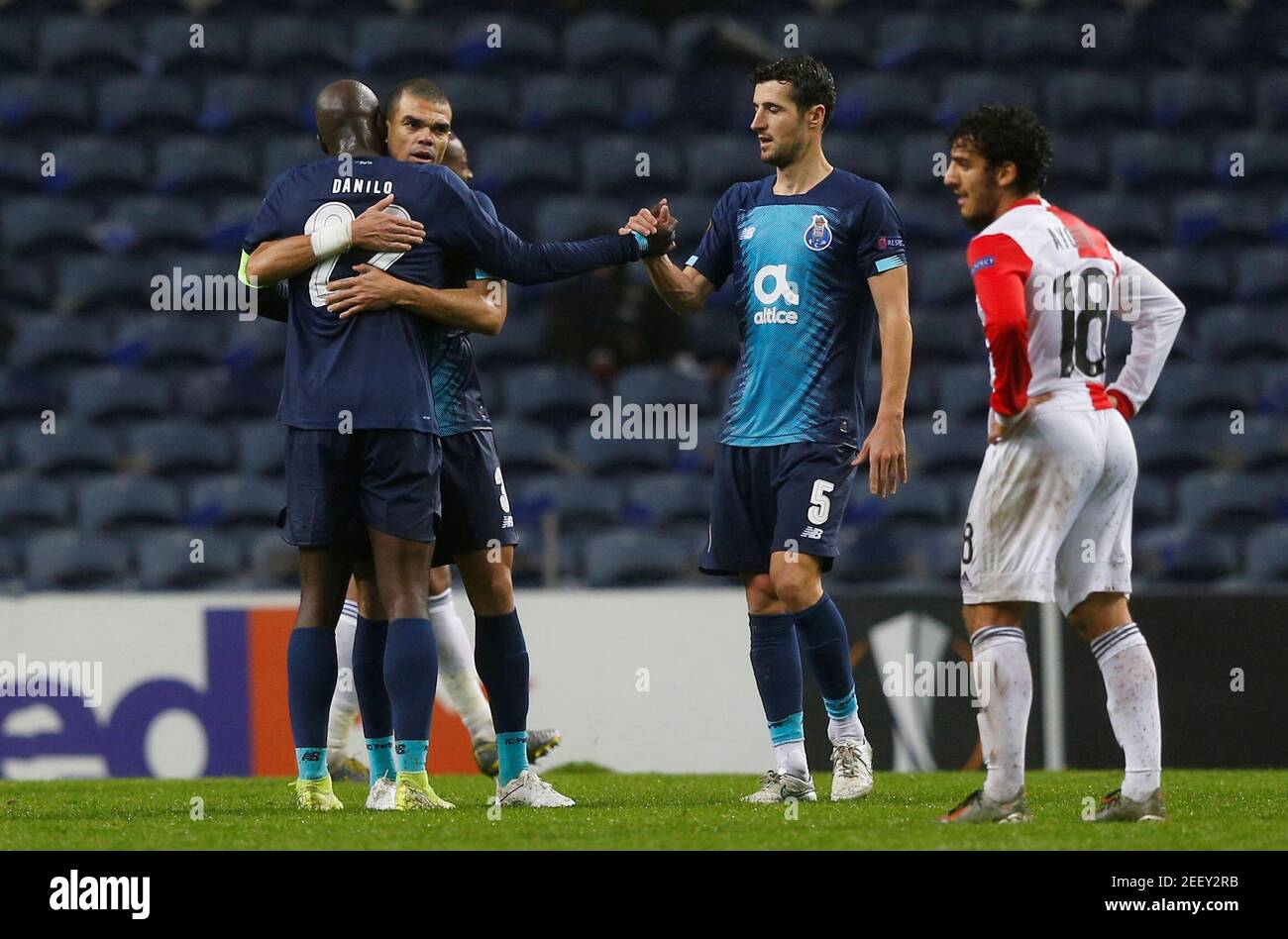 Soccer Football - Europa League - Group G - FC Porto v Feyenoord - Estadio do Dragao, Porto, Portugal - December 12, 2019 FC Porto's Pepe, Danilo Pereira and Ivan Marcano celebrate after the match as FeyenoordÕs Yassine Ayoub looks dejected REUTERS/Rafael Marchante Stock Photo