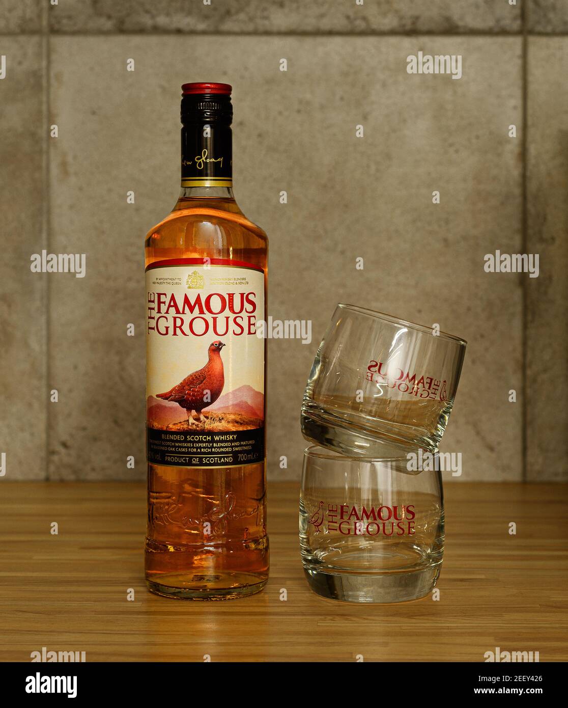 2021: bottle of the oldest scotch whisky The Famous Grouse with its brand glasses, standing in bar Stock Photo