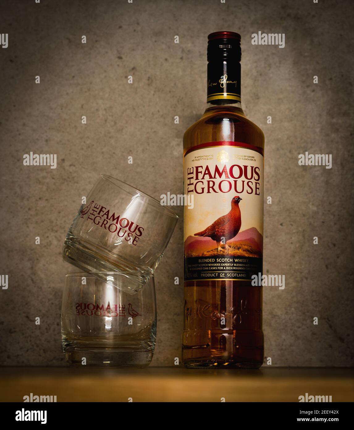 2021: bottle of the oldest scotch whisky The Famous Grouse with its brand glasses, standing in bar Stock Photo