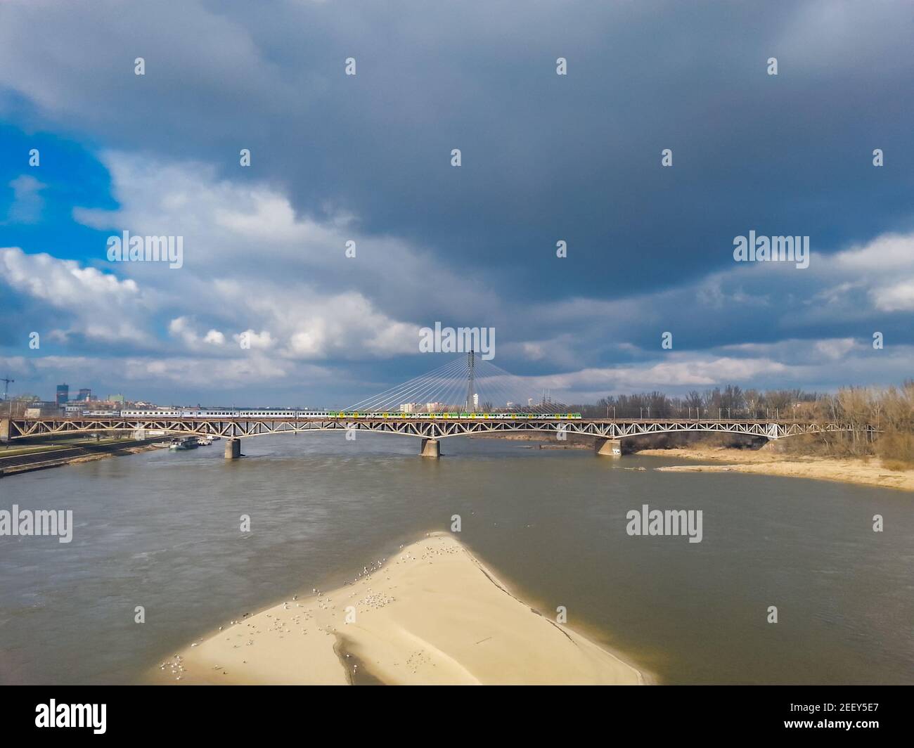 Warsaw cityscape with train bridge and small beach on coast Stock Photo