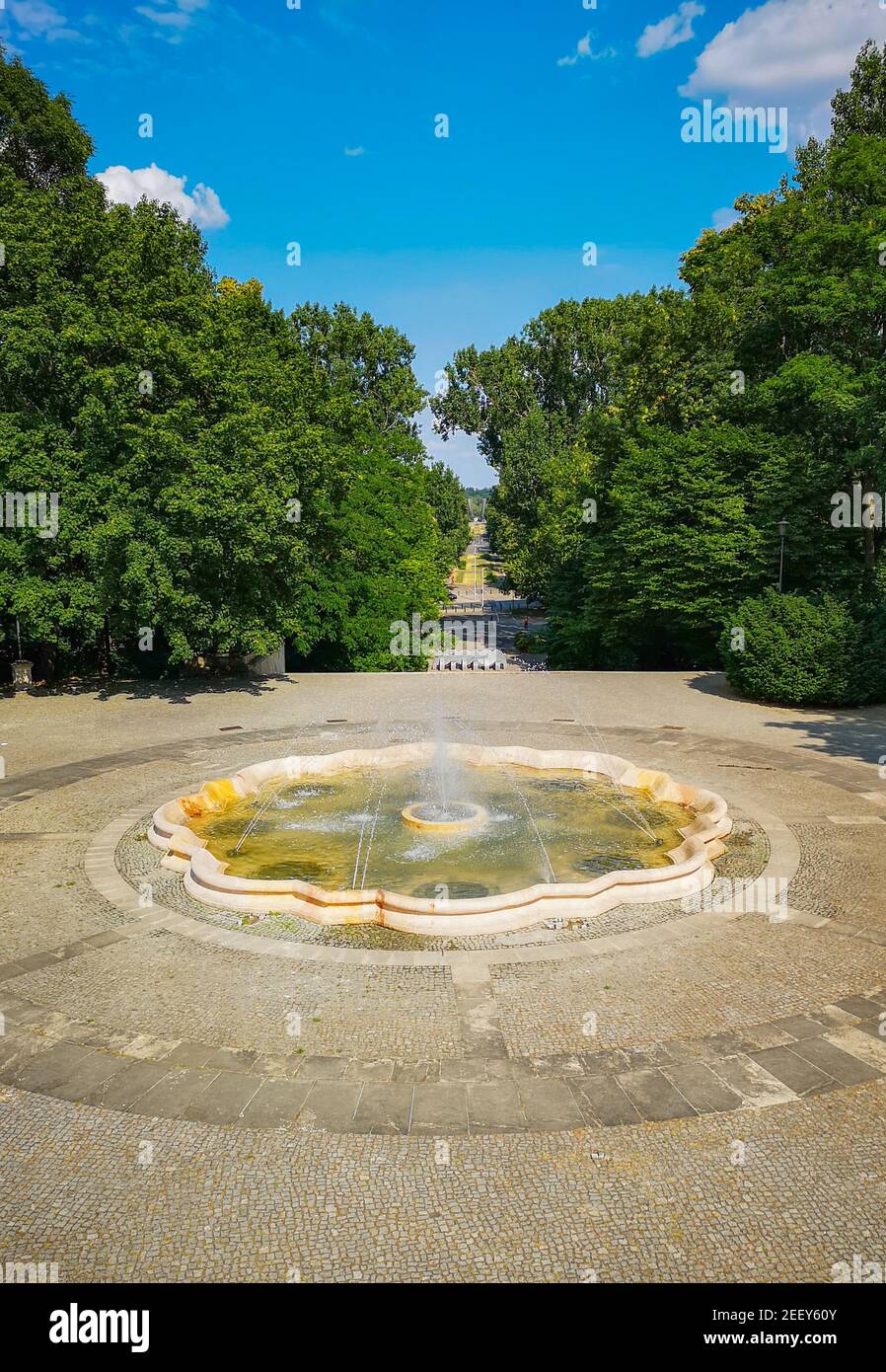 Fountain square with long pathway with concrete pavement Stock Photo