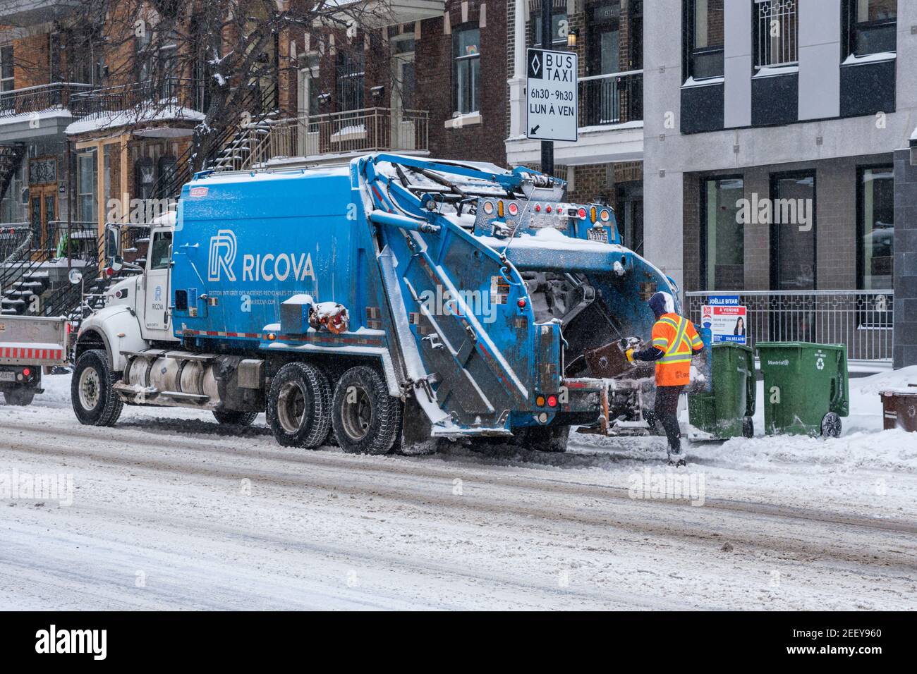 Montreal, CA 16 February 2021 City worker emptying garbage into