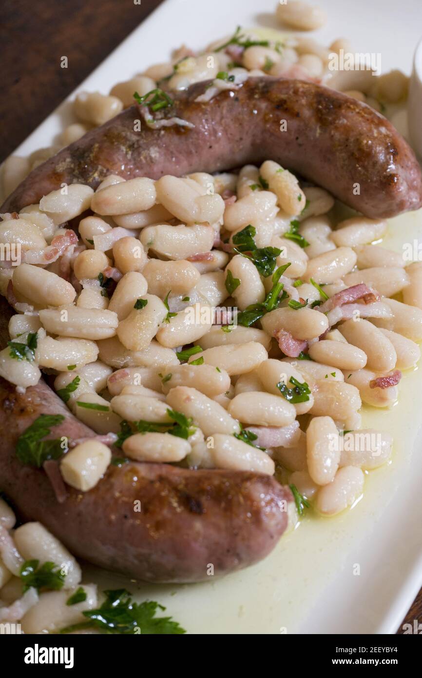 Vertical shot of pork sausage with beans made on the grill Stock Photo