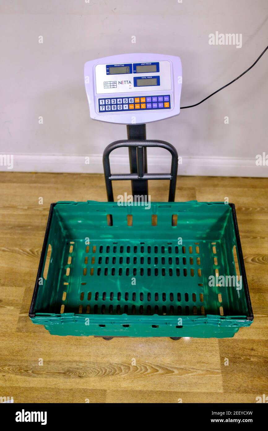 Weighing food donations on weight scales in a Trussell Trust foodbank