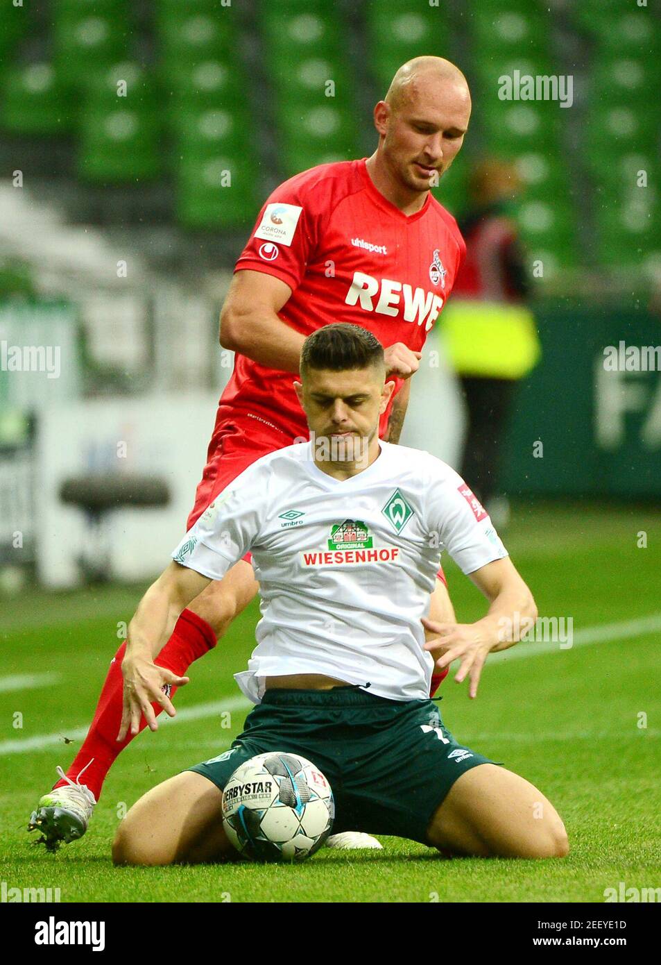 Soccer Football - Bundesliga - Werder Bremen v FC Cologne - Weser-Stadion, Bremen, Germany - June 27, 2020 Bremen's Milot Rashica in action with Cologne's Toni Leistner, following the resumption of play behind closed doors after the outbreak of the coronavirus disease (COVID-19)  Patrik Stollarz/Pool via REUTERS  DFL regulations prohibit any use of photographs as image sequences and/or quasi-video Stock Photo