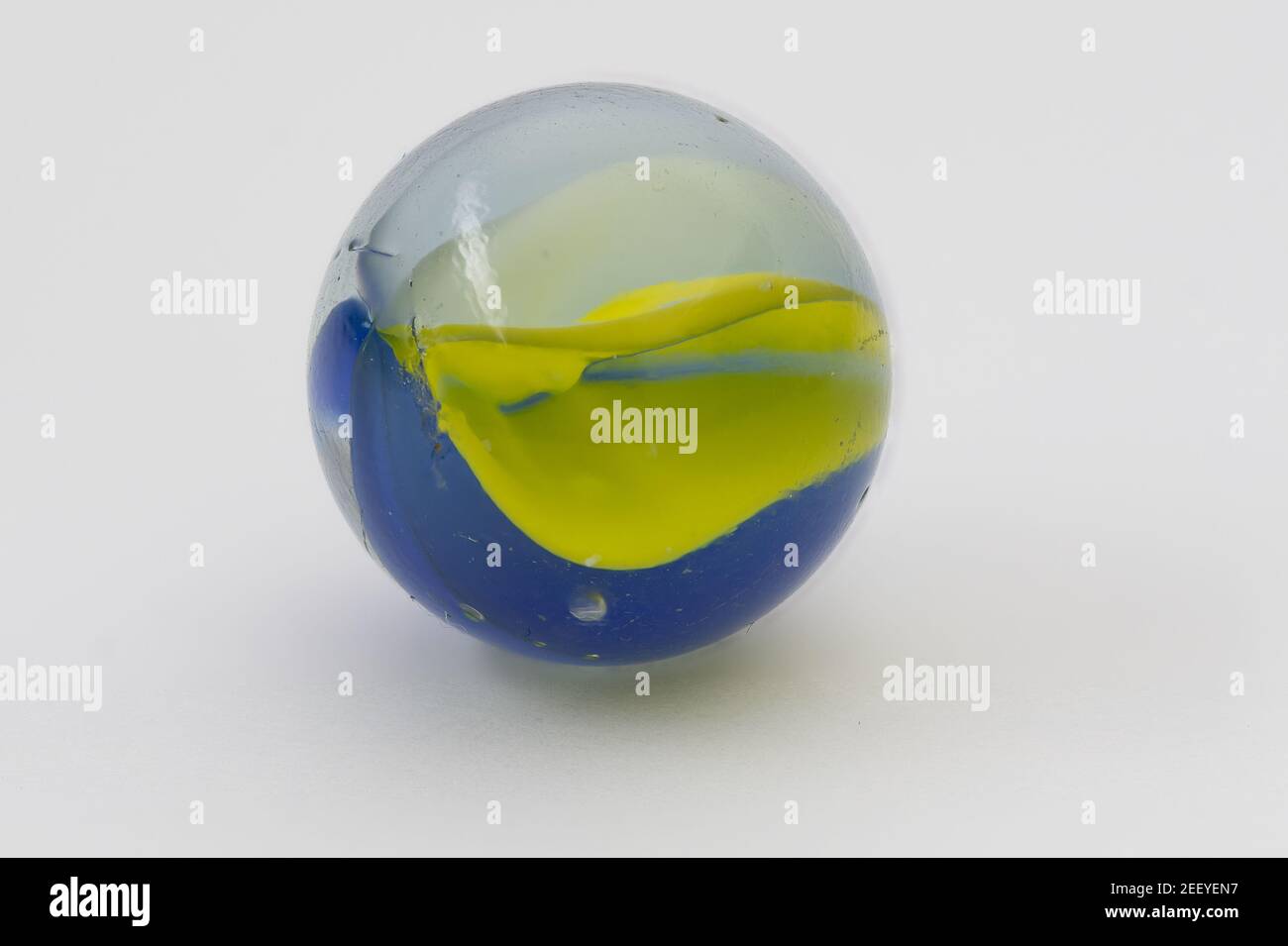 Macro image of a glass marble on a white background Stock Photo