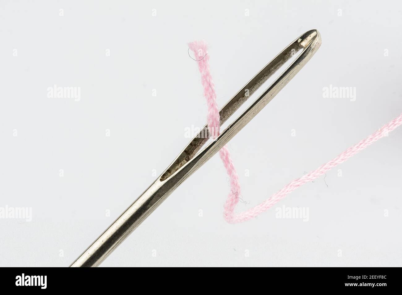 Macro image of a darning needle eye and thread Stock Photo Alamy