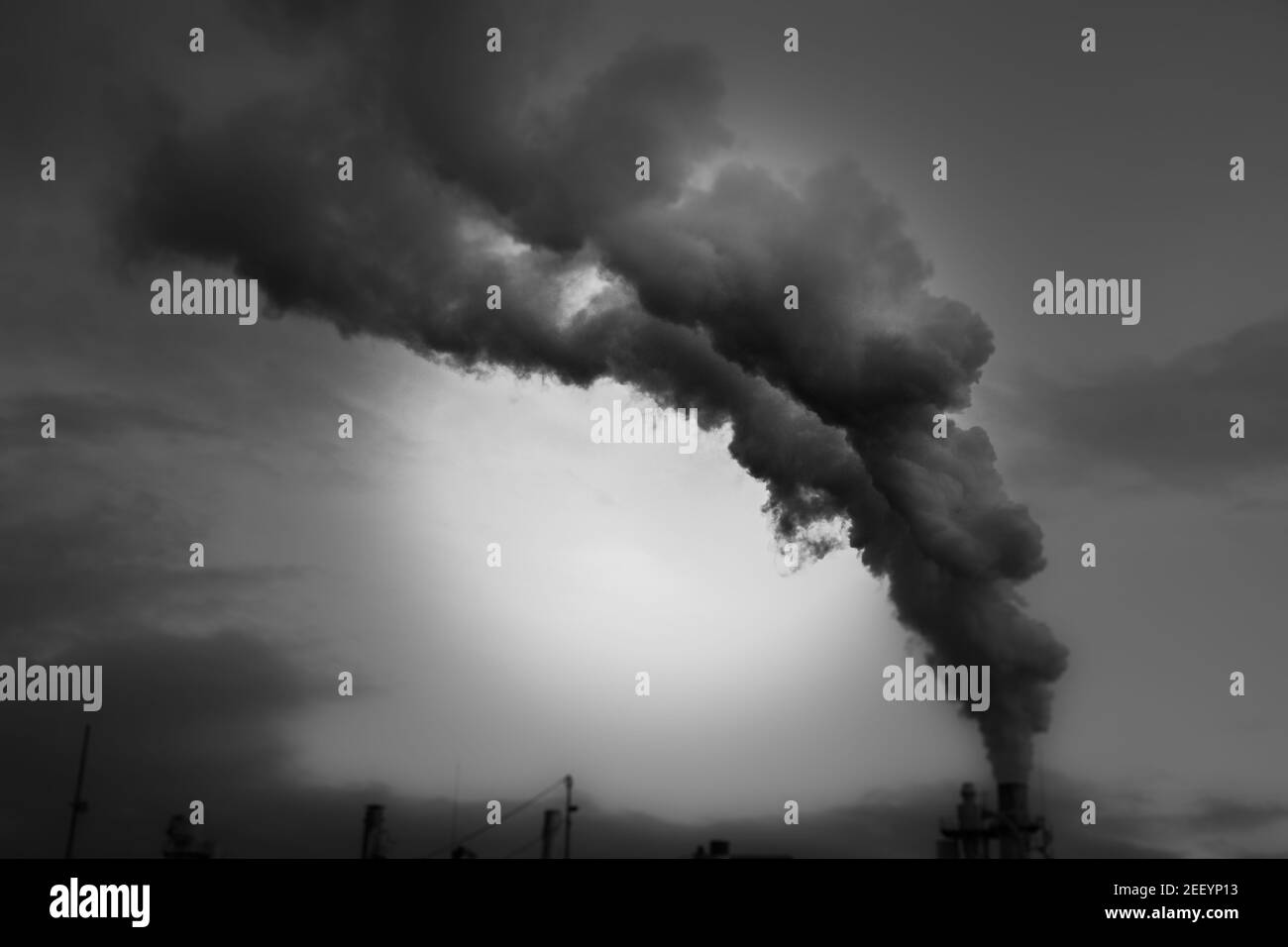 smoke coming out of factory chimney industry and global warming Stock Photo