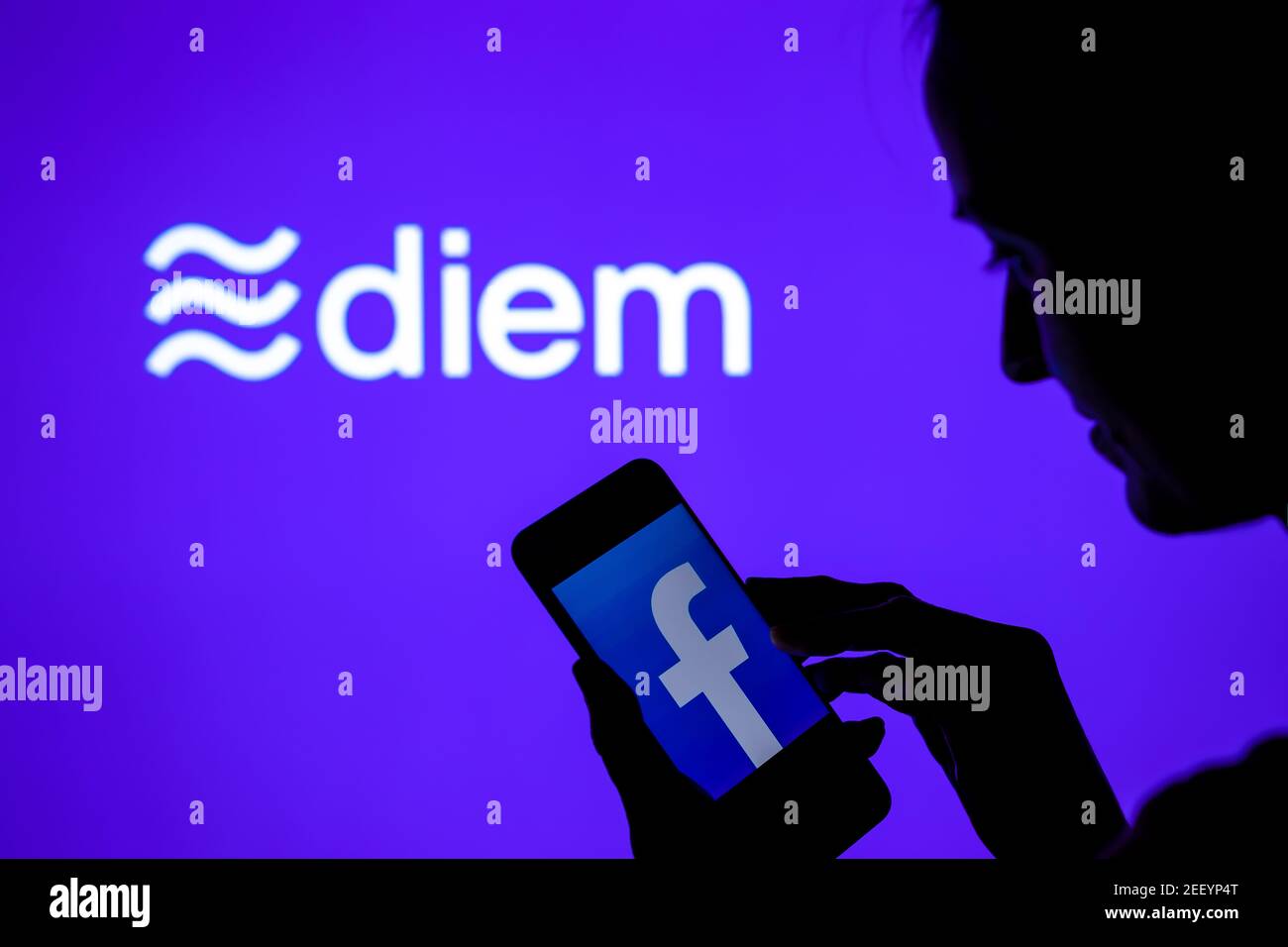 Silhouette of a girl with smartphone and Facebook Diem cryptocurrency logo on the blurred screen. Real photo, not a montage, no edit in post. Stafford Stock Photo