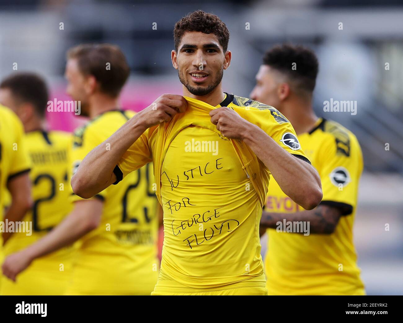 Soccer Football - Bundesliga - SC Paderborn v Borussia Dortmund - Benteler Arena, Paderborn, Germany - May 31, 2020 Borussia Dortmund's Achraf Hakimi celebrates scoring their fourth goal with a 'Justice for George Floyd' shirt, as play resumes behind closed doors following the outbreak of the coronavirus disease (COVID-19) Lars Baron/Pool via REUTERS   DFL regulations prohibit any use of photographs as image sequences and/or quasi-video Stock Photo