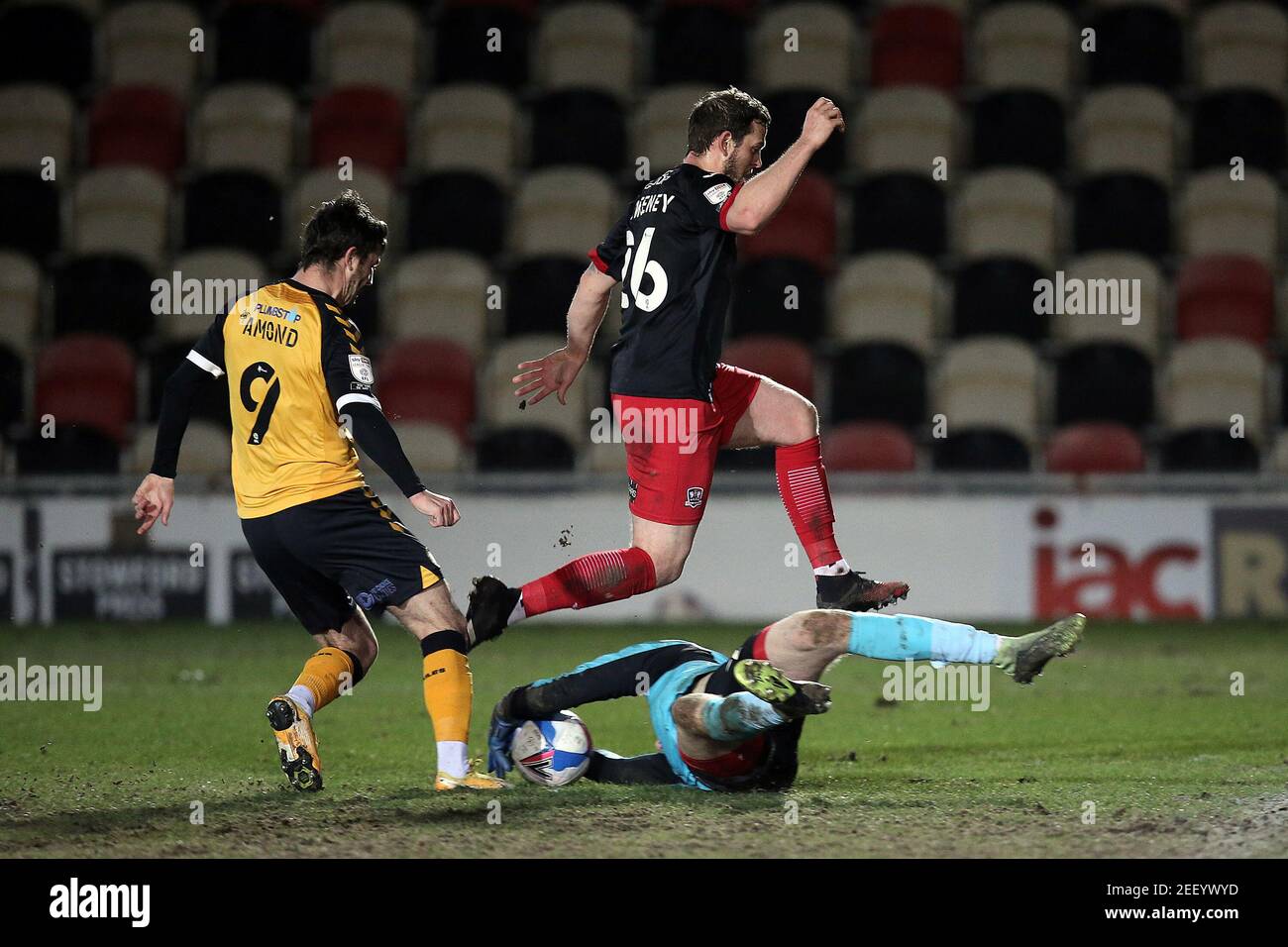Newport, UK. 16th Feb, 2021. Pierce Sweeney of Exeter City hurdles his own goalkeeper Jokull Andresson of Exeter City as Padraig Amond of Newport County hopes to pounce during the EFL Sky Bet League 2 match between Newport County and Exeter City at Rodney Parade, Newport, Wales on 16 February 2021. Photo by Dave Peters. Editorial use only, license required for commercial use. No use in betting, games or a single club/league/player publications. Credit: UK Sports Pics Ltd/Alamy Live News Stock Photo