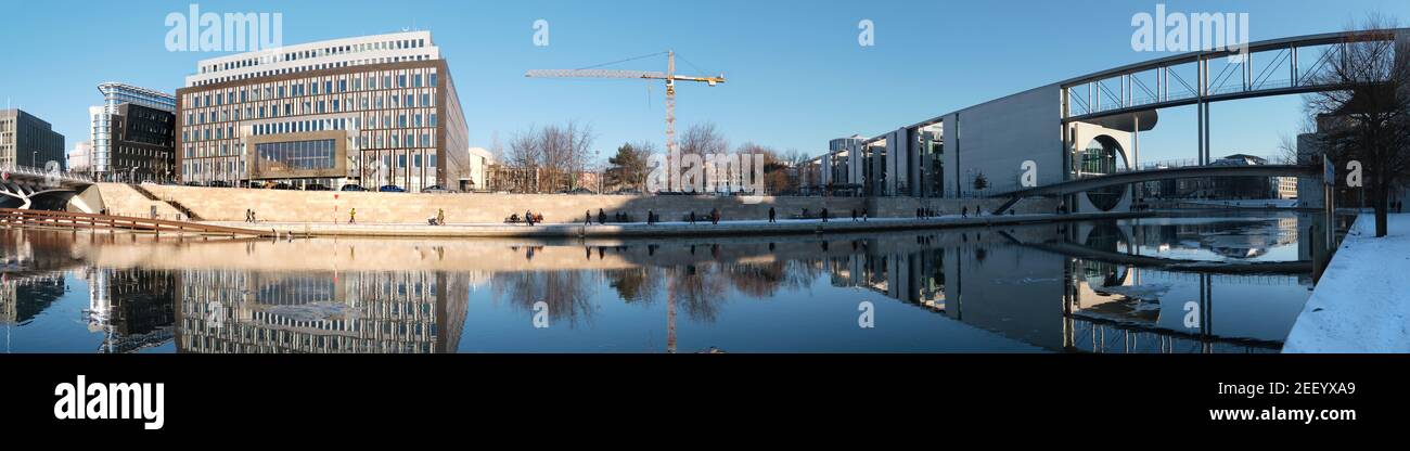 Spree riverside in winter. Panoramic view of modern architecture. Reichstag.Marie-Elisabeth-Lueders-Haus and footbridge over Spree river Stock Photo